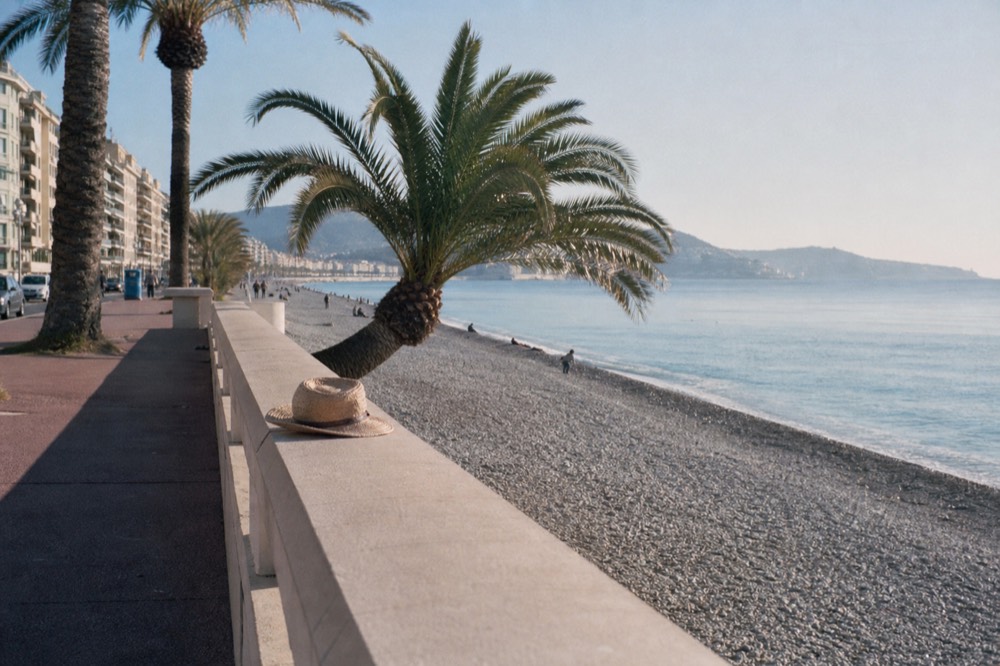 Promenade des Anglais in Nice with the blue Mediterranean and palm trees, no text, no logos, no people