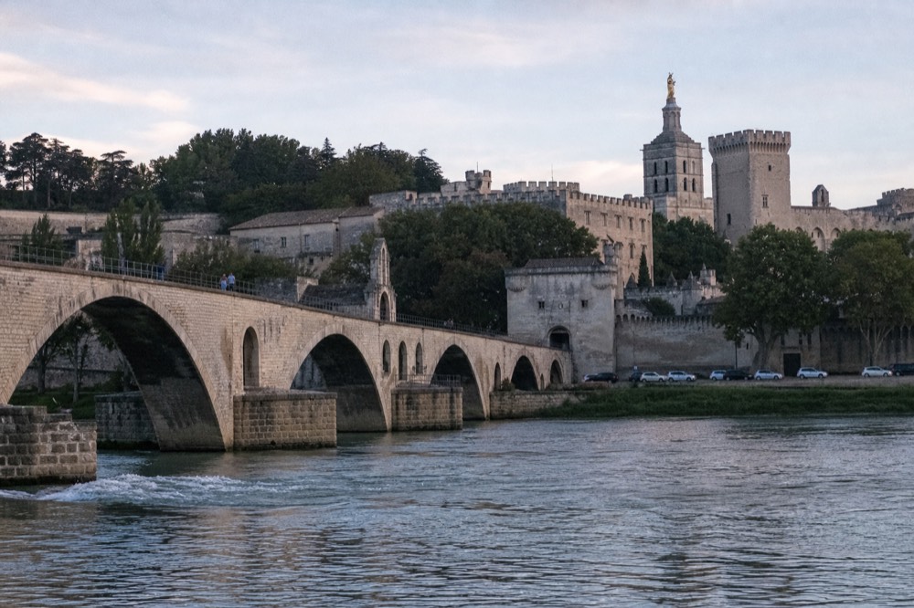 The surviving arches of the Avignon bridge reaching partway across the Rhône, no text, no logos, no people.