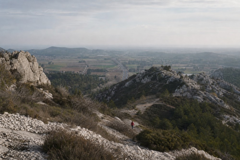 Panoramic view from a rocky outcrop over the Alpilles hills and valleys, no text, no logos, no people.