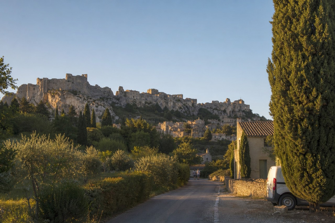 Stone village of Les Baux-de-Provence perched on a rocky ridge under a clear sky, no text, no logos, no people.