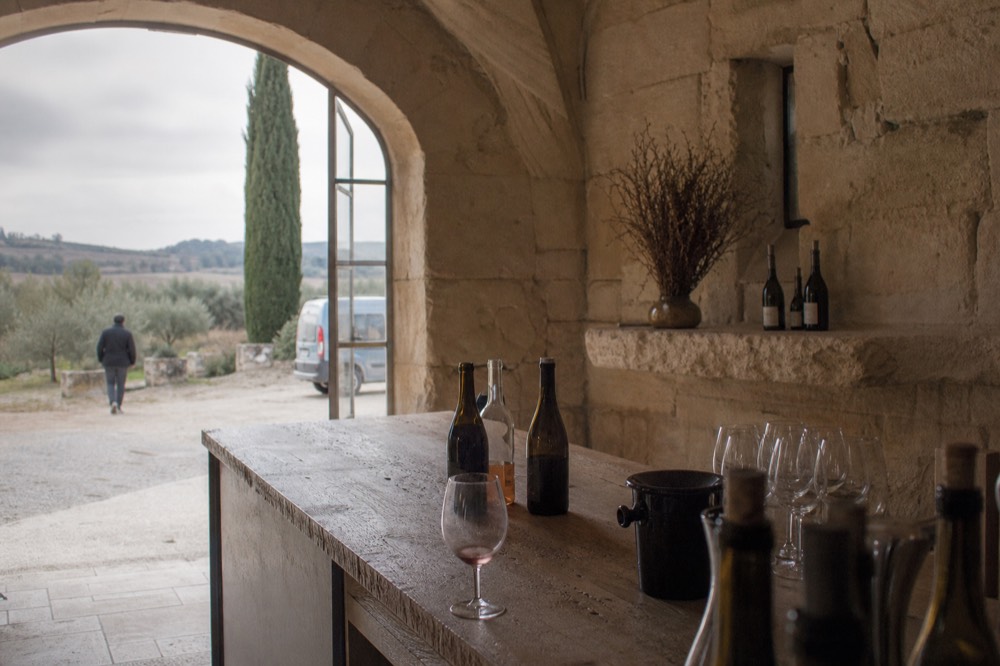 Tasting room with bottles and glasses, no text, no logos, no people