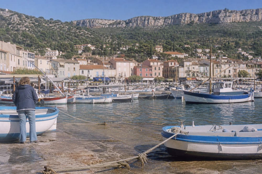 Cassis harbour with vineyard slopes rising behind the town, no text, no logos, no people
