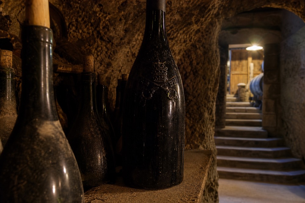 A close-up of a bottle of Châteauneuf-du-Pape with the papal crest on the label, no text, no logos, no people