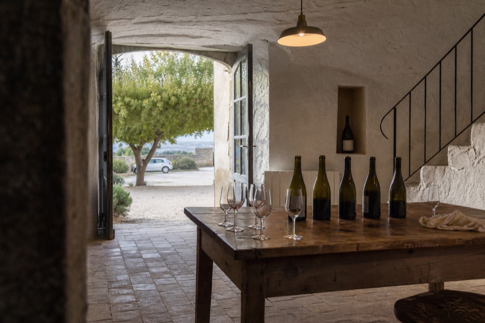 Tasting room interior with Luberon wines on a wooden table, no text, no logos, no people