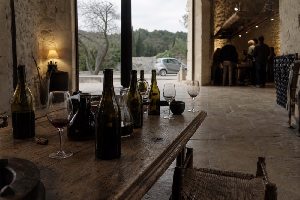 Tasting room with bottles and glasses on a wooden table, no text, no logos, no people